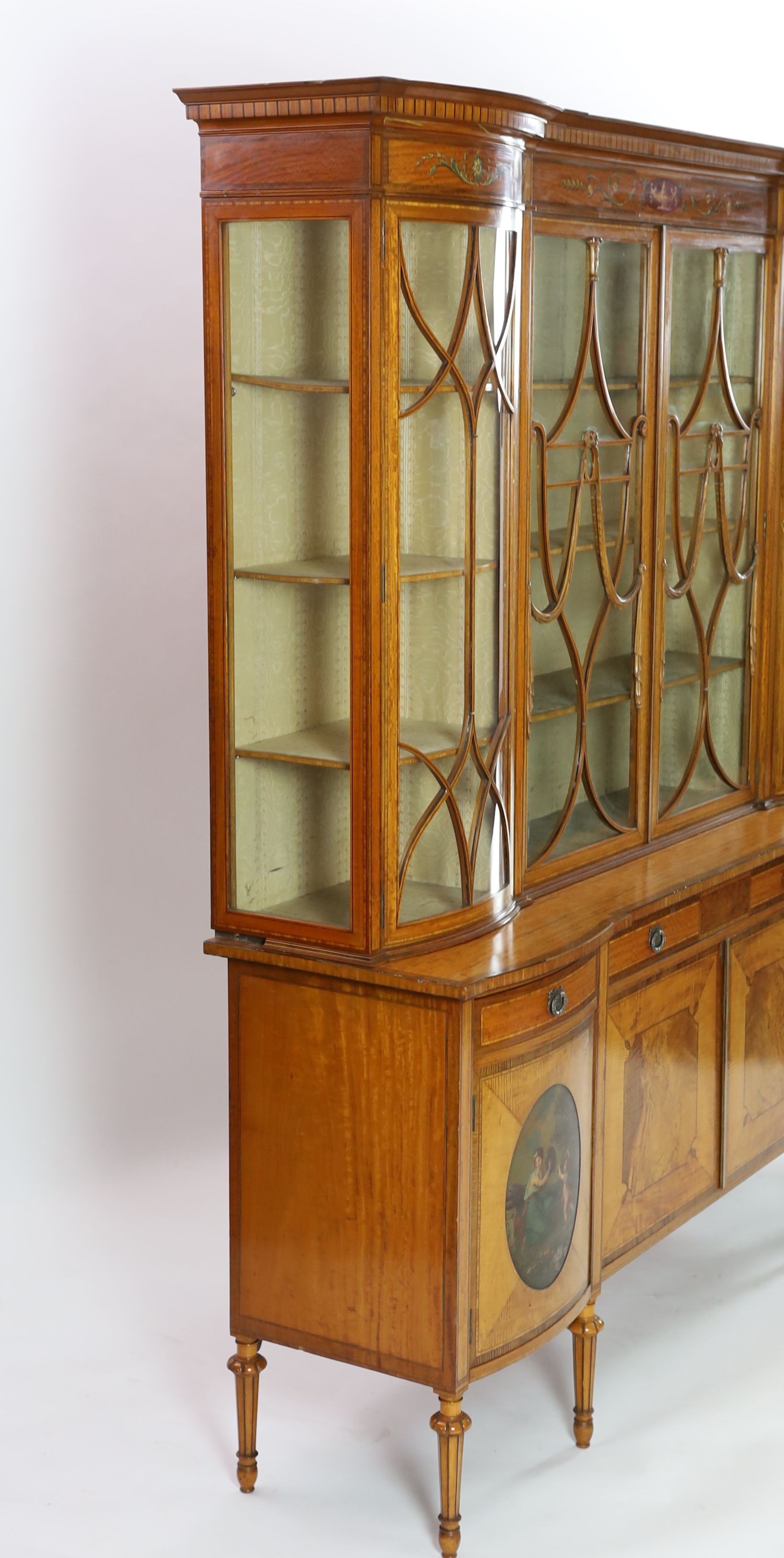 An Edwardian Sheraton revival ebony strung satinwood display cabinet, W.190cm D.47cm H.205cm